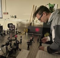 A student aligns an optical apparatus.